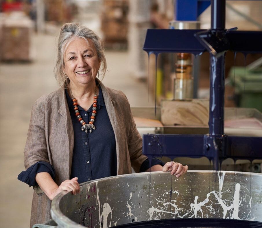 Annie Sloan in the factory in Oxford mixing Chalk Paint in Oxford Navy in a vat